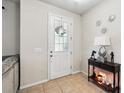 Bright foyer with tile flooring, stylish console table, and elegant front door at 2920 Windmill Dr, Kissimmee, FL 34741