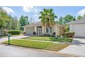 Attractive home with a lush green lawn, mature trees, and a welcoming facade at 2958 Sunset Vista Blvd, Kissimmee, FL 34747