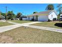 This exterior view showcases the home's one car garage, well maintained lawn and fenced yard at 3115 Via Uno, Orlando, FL 32817