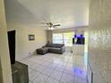 This living room has a ceiling fan and an aquarium with a gray sofa at 3115 Via Uno, Orlando, FL 32817