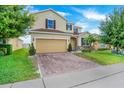 Attractive home featuring a well-maintained lawn, two-car garage, and beautiful curb appeal at 624 Sardinia Circle, Davenport, FL 33837