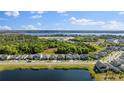 Overhead view of the community, showcasing the picturesque lake and surrounding trees at 7465 Wing Span Way, Harmony, FL 34773