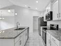 Well-equipped kitchen featuring white cabinets, stainless steel appliances, and a large island with a sink at 101 Sail Way, Kissimmee, FL 34759