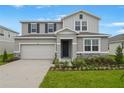 Charming two-story home with stone accents, landscaped yard, and attached two-car garage at 1027 Wisteria Way, Dundee, FL 33838