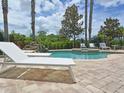 View of outdoor pool and hot tub, accompanied by seating and landscaping at 1057 Castle Pines Ct, Reunion, FL 34747