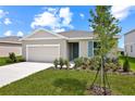 Charming single-story home with a two-car garage, landscaped yard, and lovely blue shutter at 1114 Olivine Ave, Dundee, FL 33838