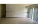 Bright dining area with tiled floor, neutral paint, and sliding glass door, perfect for entertaining at 1304 Mill Creek Pl, Kissimmee, FL 34744