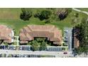 An aerial view showcasing the tile roofs and landscaping of the multi-story condo building at 14049 Fairway Island Dr # 122, Orlando, FL 32837