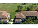 An aerial view of the residential buildings showcasing the tile roofing and manicured lawns at 14049 Fairway Island Dr # 122, Orlando, FL 32837