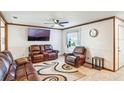 Comfortable living room with leather seating, a ceiling fan, and a wall-mounted TV at 2429 Oak Run Blvd, Kissimmee, FL 34744