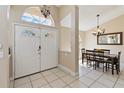 Bright foyer with tiled floors, a double door entrance, high ceilings, and an adjacent dining area at 2706 Sebastian Ct, Kissimmee, FL 34743