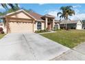 Attractive single-Gathering home with a well-kept lawn, a concrete driveway, and a convenient two-car garage at 2706 Sebastian Ct, Kissimmee, FL 34743