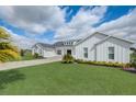 Stunning modern farmhouse with brick drive, manicured lawn, and three-car garage at 3409 Lake Diane Rd, Tavares, FL 32778