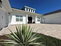 Beautiful modern farmhouse with a brick driveway, well-manicured yard, and a three-car garage at 3409 Lake Diane Rd, Tavares, FL 32778