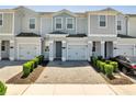 Charming townhome with brick driveway, one car garage, and manicured landscaping at 4672 Tribute Trl, Kissimmee, FL 34746