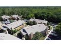 Scenic aerial view of the condo community nestled among lush green trees and well-manicured lawns at 4858 S Semoran Blvd # 2108, Orlando, FL 32822