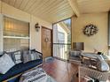 Relaxing screened-in patio featuring comfortable seating, tile flooring, and a cozy, welcoming ambiance at 4858 S Semoran Blvd # 2108, Orlando, FL 32822