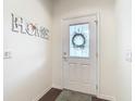 Bright and inviting foyer with a decorative door and a welcoming atmosphere at 501 Heartwell Dr, Poinciana, FL 34759