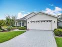 Charming one-story home with a wide driveway and a large two-car garage at 501 Heartwell Dr, Poinciana, FL 34759