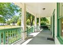 Spacious covered porch with ample seating, perfect for relaxing outdoors and enjoying the neighborhood views at 5641 Orange Ave, Intercession City, FL 33848