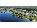 Aerial view of home and waterway with mature trees and beautiful landscaping at 585 Grand Canal Dr, Poinciana, FL 34759