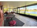 Inviting enclosed patio overlooking a picturesque canal, perfect for relaxing and enjoying outdoor living at 585 Grand Canal Dr, Poinciana, FL 34759