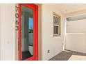 Contemporary front door with a glass panel and the house number, creating curb appeal at 7063 Nemours Pkwy, Orlando, FL 32827