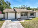 Charming single-Gathering home with a well-maintained lawn, attached garage, and inviting front entrance at 11125 Finchley Pl, Orlando, FL 32837