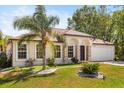 Charming single-story home with a well-manicured lawn and lush landscaping at 1129 Dartford Dr, Kissimmee, FL 34758