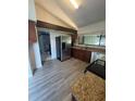 Bright kitchen featuring granite countertops, stainless steel appliances, and laminate flooring at 12 Robyn Ln, Haines City, FL 33844