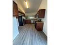 Spacious kitchen equipped with stainless steel appliances, wooden cabinets and granite countertops at 12 Robyn Ln, Haines City, FL 33844