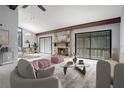 Stylishly furnished living room featuring a cozy fireplace, ample seating, and an adjacent dining area at 12 Robyn Ln, Haines City, FL 33844