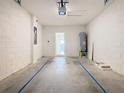 Spacious two car garage with white brick walls and visible mechanicals at 12035 Holystone St, Winter Garden, FL 34787