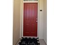 Charming red front door with welcome mat, unit 309, for a cozy entrance at 1230 Wright Cir # 5309, Celebration, FL 34747