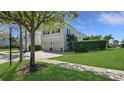 Charming two-story home boasts a well-maintained lawn and a two-car garage at 1506 Euston Dr, Reunion, FL 34747
