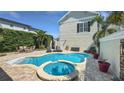 Relaxing backyard boasts a private pool and spa, surrounded by lush landscaping at 1506 Euston Dr, Reunion, FL 34747