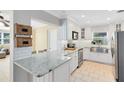 Bright, white kitchen showcasing granite countertops, stainless steel appliances, and ample cabinetry at 1510 E Ridgewood St, Orlando, FL 32803
