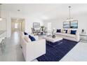 Bright, open-concept living room with tile flooring, stylish furniture, and ample natural light at 219 Summerlin Loop, Haines City, FL 33844