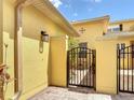 Enclosed brick-paver courtyard with iron gate at 2502 Palm Tree Dr, Poinciana, FL 34759