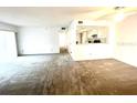 Open living room with carpeted flooring, neutral colors, and a view into the kitchen area at 2538 Citrus Club Ln # 105, Orlando, FL 32839