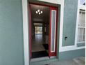 View from the doorway into the foyer with tile flooring and neutral paint at 2714 University Acres Dr, Orlando, FL 32817