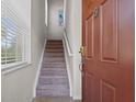 Entryway featuring a carpeted staircase leading to the upper level of the home at 2835 Oakwater Dr # 2835, Kissimmee, FL 34747