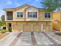 Inviting townhome exterior with garages, complemented by well-maintained landscaping at 2835 Oakwater Dr # 2835, Kissimmee, FL 34747
