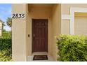Close-up of the front door of home 2835 with plants and a 