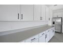 Bright kitchen features white cabinets, stainless steel appliances and stone countertops at 2943 Gavin Sky Dr, Kissimmee, FL 34744