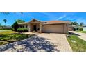 Charming single-story home with a well-maintained lawn and a spacious two-car garage at 300 Falling Water Dr, Kissimmee, FL 34759