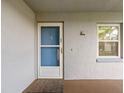 Apartment entrance featuring a screen door, small window, and a welcome mat at 333 Lake Howard Dr Nw # 204D, Winter Haven, FL 33880