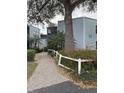 A well-maintained building exterior with mature trees and landscaping leading to the entrance at 3592 Southpointe Dr # 2, Orlando, FL 32822