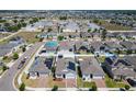 Expansive aerial view of neighborhood homes, showcasing their proximity, solar panels, and community layout at 372 Meadow Pointe Dr, Haines City, FL 33844