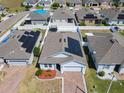 Birds eye view of home highlighting the solar panels, brick driveway, and manicured landscaping at 372 Meadow Pointe Dr, Haines City, FL 33844